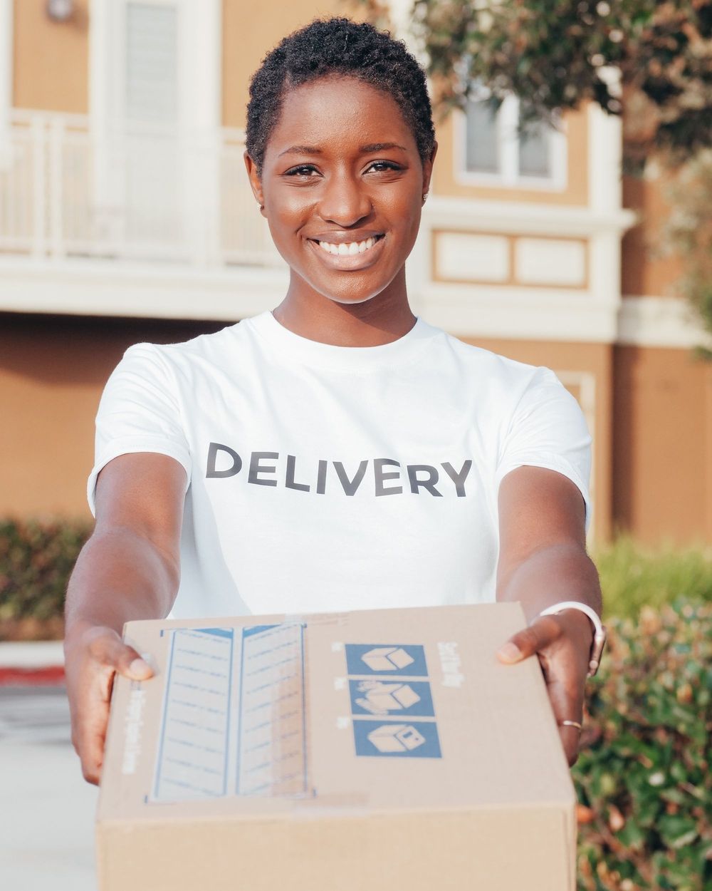 A professional courier handing over a package